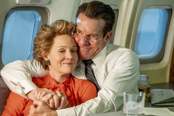 Dennis Quaid and Penelope Ann Miller in a scene from the film 'Reagan', hugging on an airplane
