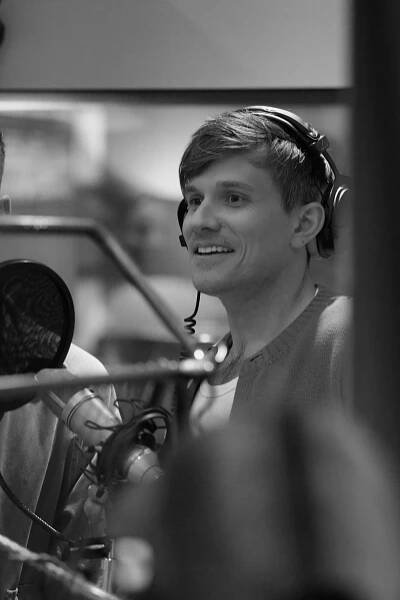 Black and white photo of Fleur East and Will Best in a recording studio.