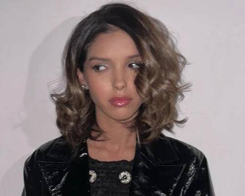 actor lyna khoudri with her hair in short, loose waves