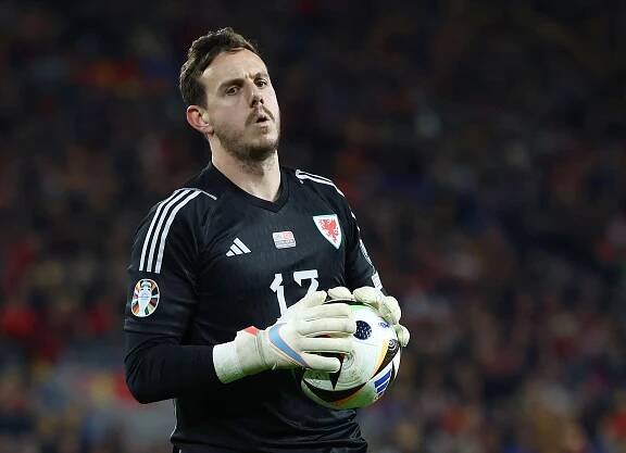 Danny Ward of Wales holding a soccer ball.