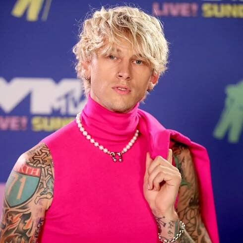 Machine Gun Kelly with an angular fringe men's haircut. 