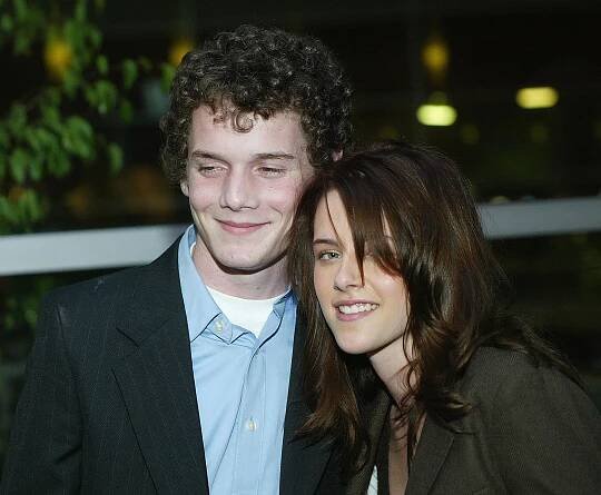 Anton Yelchin and Kristen Stewart at a cocktail reception.