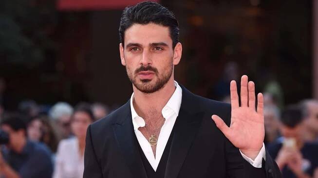 Italian actor Michele Morrone looking directly in the camera.