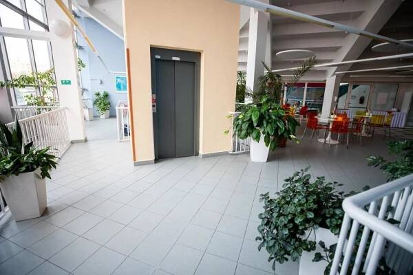 an empty hallway of a building with plants at Hotel Sport in Karviná