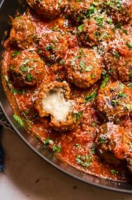 Mozzarella Stuffed Meatballs are cheesy, melty Italian meatballs perfect for appetizers or topping your favorite Italian main dish. 