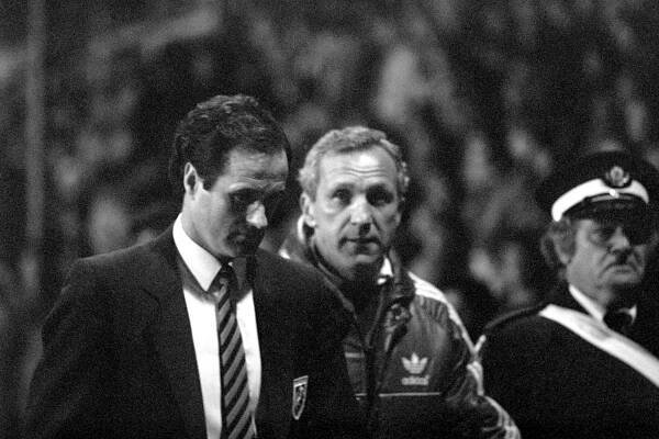 Black and white photo of Millwall manager George Graham and his assistant Theo Foley looking dejected after a match.