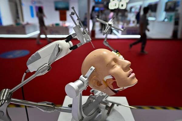 A robotic arm for surgery is displayed at the 2023 World Robot Conference in Beijing on August 16. China is under pressure to narrow the tech gap with advanced economies. Photo: AFP