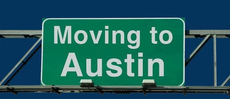 A green highway sign reading "Moving to Austin," symbolizing one of the top reasons to move to austin.
