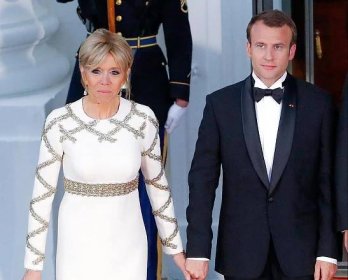  President Macron holds hands with his wife Brigitte