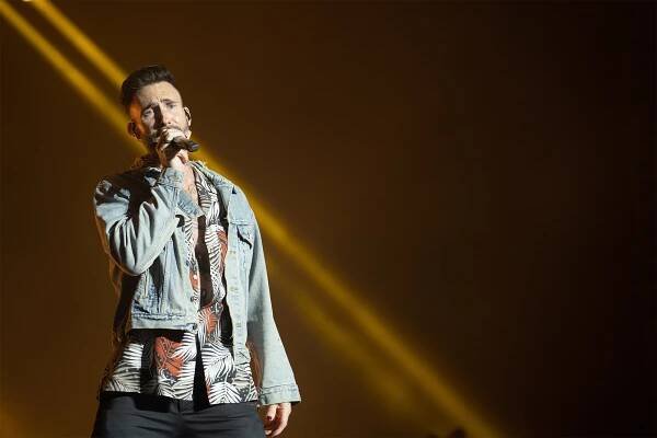 Maroon 5 lead singer Adam Levine croons onstage.