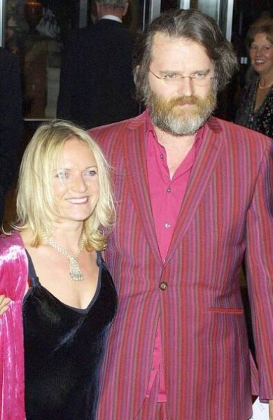 Sarah Parkinson smiles as Paul Merton puts his arm around her at an event