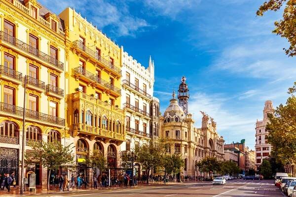 Plaza del Ayuntamiento in Valencia, Spain, with historic buildings on a sunny day.
