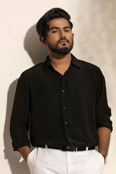 Free Portrait of a man in black shirt posing confidently in a Dhaka, Bangladesh fashion photoshoot. Stock Photo