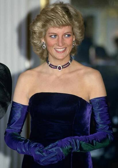 Diana, Princess Of Wales, Wearing A Purple Velvet Sleeveless Evening Dress Designed By Catherine Walker With Matching Choker And Earrings For A Performance Of Mozart's Opera 