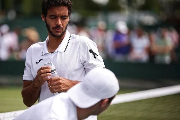 Francisco Cabral, wearing a black armband, at Wimbledon.