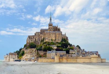Brown concrete castle on the beach during the daytime, Mont Saint Michel