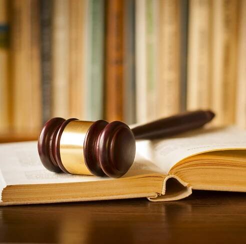 Open law book with a judges gavel