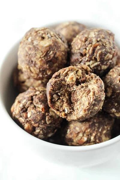 a bowl of Chocolate Peanut Butter Snack Ball with a bite taken out of one