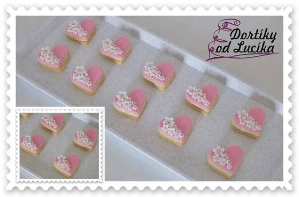 a box filled with heart shaped cookies on top of a table
