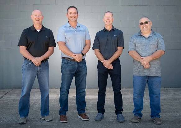 Todd Outman, Mike Deputy, Jimmy Rogers, and Marc Wilma posing casually for a picture