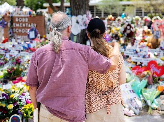 People visit a memorial in June outside of Robb Elementary School where 19 children and two teachers were killed in May’s shooting in Uvalde. Some mental health advocates worry that the focus on violence in relation to mental health could deter individuals from seeking help.