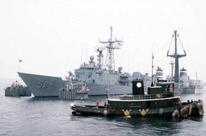 The Dutch salvage ship MIGHTY SERVANT II prepares to lift the guided missile frigate USS SAMUEL B. ROBERTS (FFG-58) onto its deck for transport back to its home port in Newport, R.I.  The frigate was damaged after it struck a mine in the Persian Gulf on 14 April 1988.