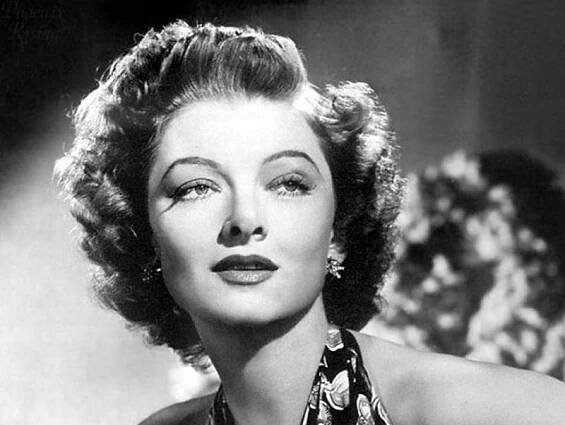 Myrna Loy in colorful top and earrings