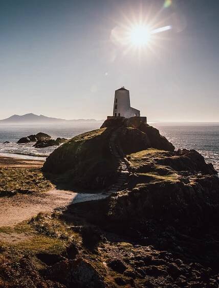Image of the lighthouse and beach at Ynys Llanddwyn in the bright winter sun.