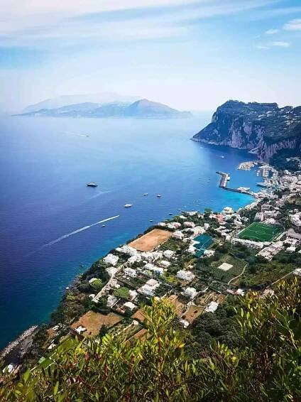 a scenic view of Anacapri town next to a large body of water