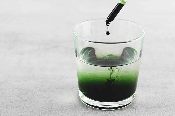 Liquid Chlorophyll in a Glass of Water, Superfood, Healthy Eating, Detox and Diet Concept