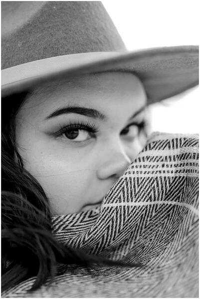 BW girl looking over shoulder holding scarf in Birdville High Senior Shoot 2020