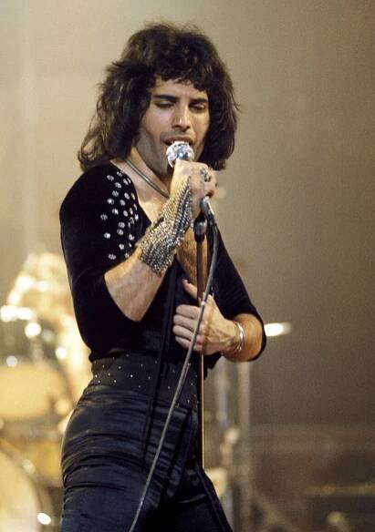 Freddie Mercury of Queen performing on stage.