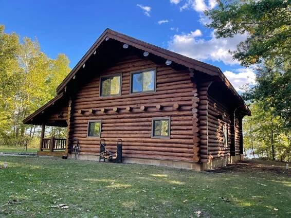 Log Cabin Sitting in the Middle of a Field – MN - Lifetime Staining and Log Restoration