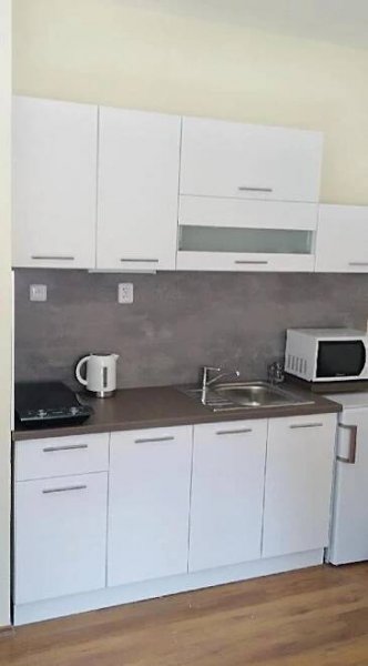 a kitchen with white cabinets and a sink at Apartmány Divoký Anděl in Dolní Moravice