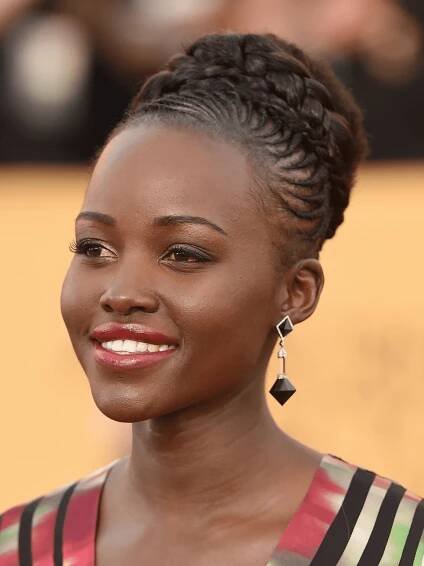 Lupita Nyong'o in micro cornrows going back into jumbo braided bun