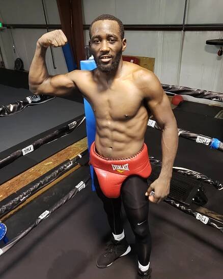 Boxer flexing in boxing ring.