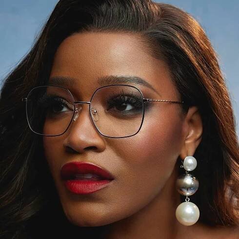 Keke Palmer with Zenni Optical glasses, red lipstick, and silver French tip nails