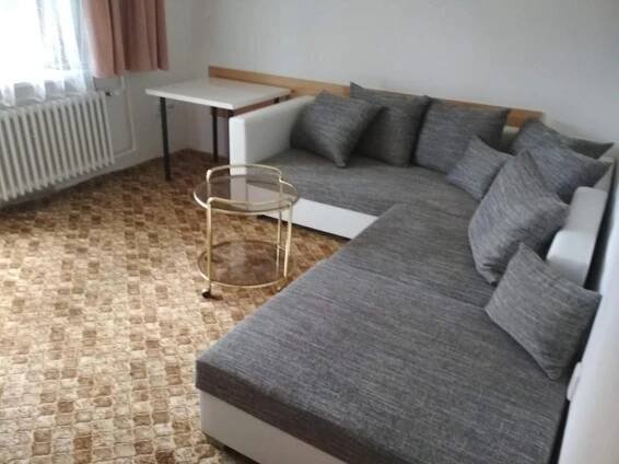 a living room with a couch and a table at Penzion Beta in Luhačovice
