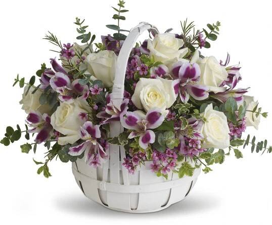 a basket filled with white and purple flowers