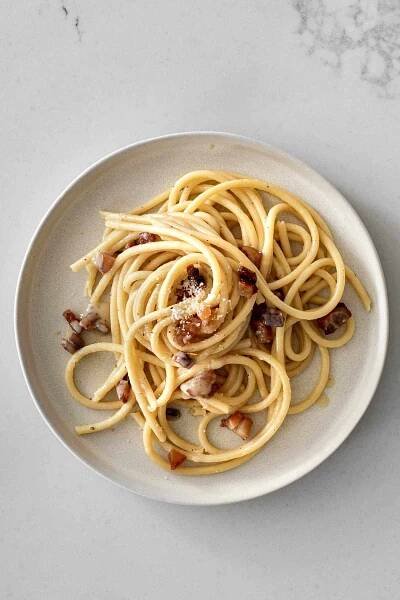 carbonara on a plate topped with guanciale, pepper and pecorino.