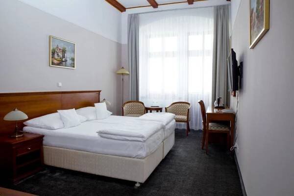 En eller flere senger på et rom på Wellness Hotel Ida