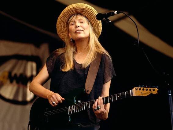 Joni Mitchell performing on stage at the New Orleans Jazz Festival.