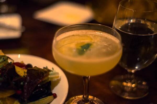 Cocktail glass and meal at Disneyland's Carthay Circle Restaurant