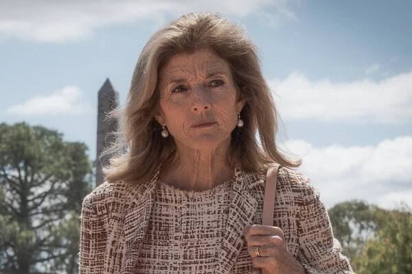 Caroline Kennedy outside in front of trees and an obelisk.