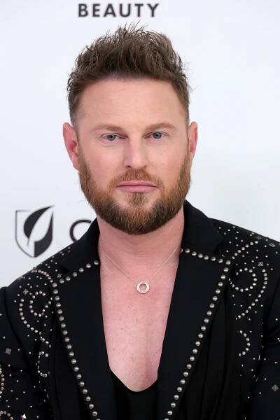 Person in a studded blazer at an event, posing for a photo