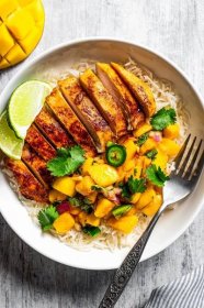 Mango chicken is made of chicken marinated in a sweet, smokey, citrusy sauce, cooked in a hot pan, and served with a sweet, spicy mango salsa.