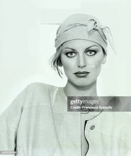 Italian actress Dalila di Lazzaro, in close-up, wearing one-button cashmere/silk tunic by Geoffrey Beene, with scarf wrapped around her head.