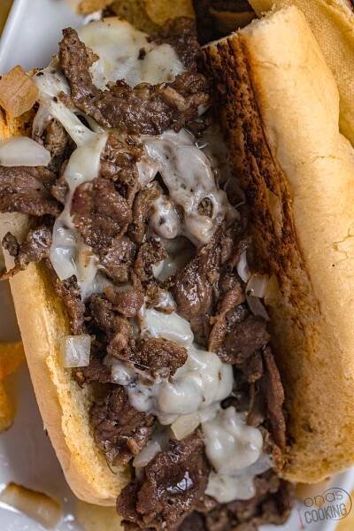 The only ingredients in an Authentic Philly cheesesteak are thinly sliced steak, fried onions, and cheese! This Philly cheesesteak recipe is true to the original Cheesesteak sandwich and is made with tender shavings of beef, sauteed onions, and cheese all tucked inside toasted long bread! 