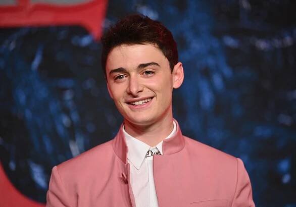 Noah Schnapp wearing a pink suit