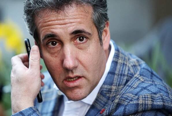 Image may contain Michael D. Cohen Human Person Electronics Phone Mobile Phone Cell Phone and Finger